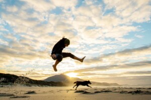 Boy jumping on beach in Albany, WA