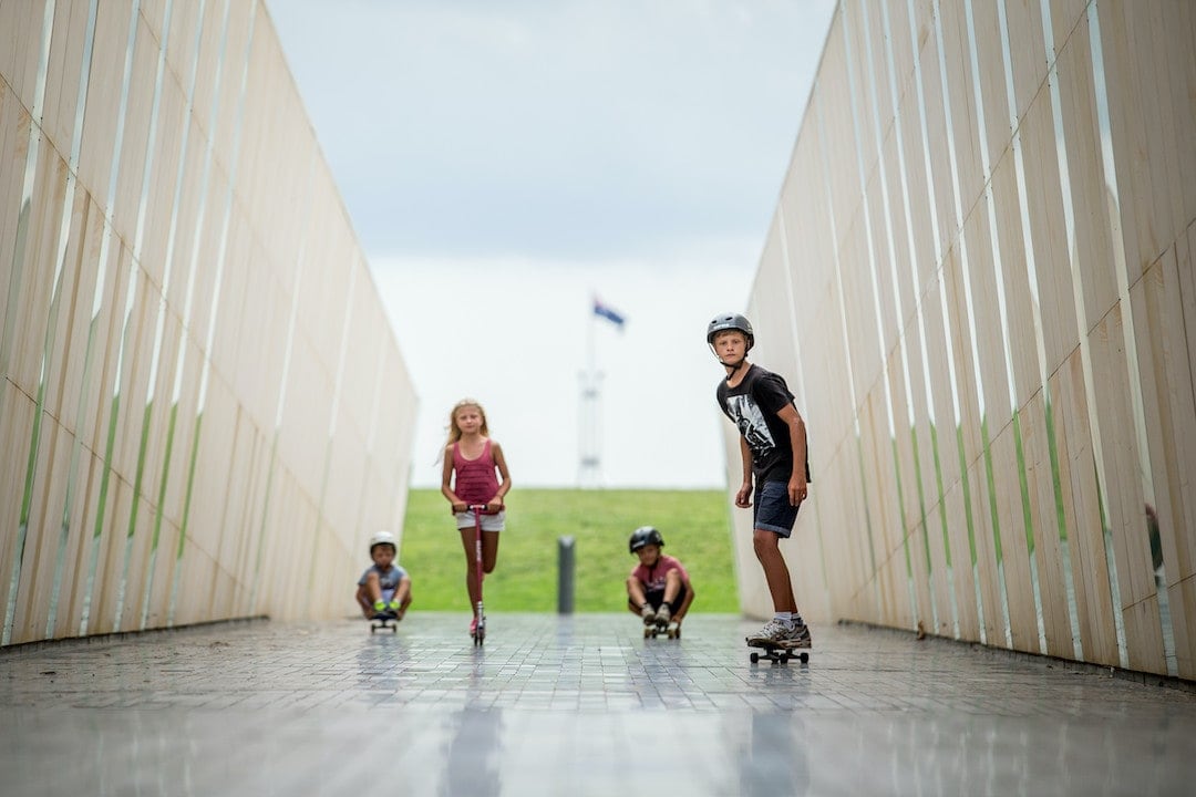 Kids scooting around Commonwealth Place, Canberra activities