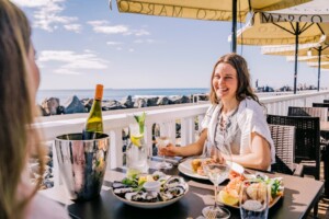 Friends enjoying food and drink at Latitude 30, Coffs Harbour.