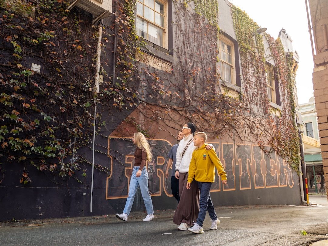 A family walking past street art in Toowoomba. Image: Tourism and Events Queensland.