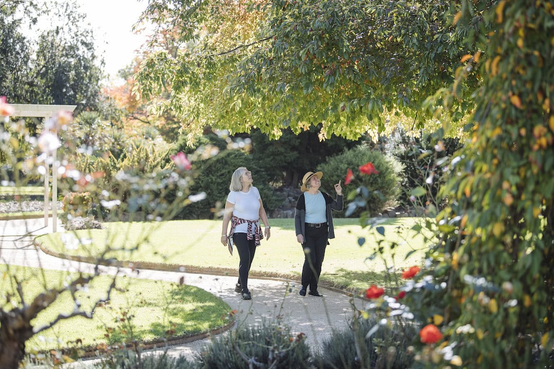 Friends enjoy the Albury Botanic Gardens, a botanical garden located in the city of Albury, New South Wales. The garden was established in 1877 and forms an example of the mainstream ideas about gardening in the 19th and 20th centuries.